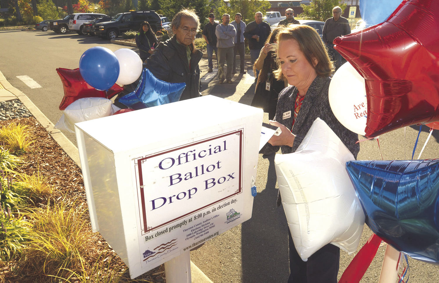 2018 FILE PHOTO — Thurston County Auditor Mary Hall officially unlocks a new ballot box installed outside the Nisqually Administration Building.